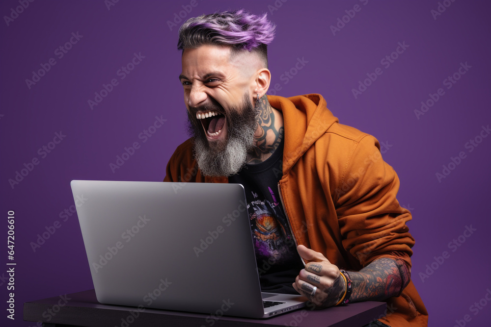 Male with beard and laptop on a purple background, happiness and joy Male with beard and laptop on a purple background, happiness and joy