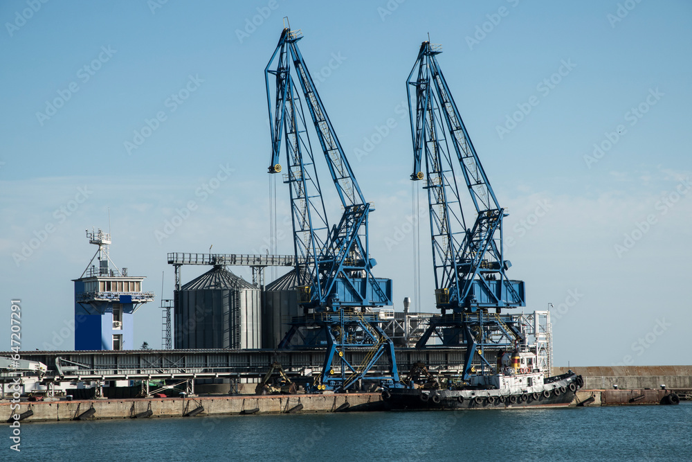 Sea landscape with port cranes in sunny summer day