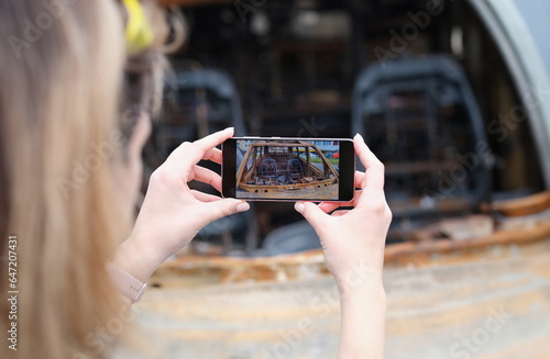Agent or journalist takes photo of car after fire and explosion. Looting arson and terrorism.