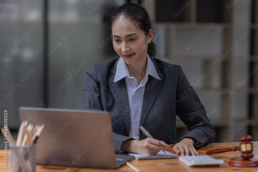justice and law concept.business asian woman or lawyer or accountant working using a laptop at desk justice and law concept.business asian woman or lawyer or accountant working using a laptop at desk