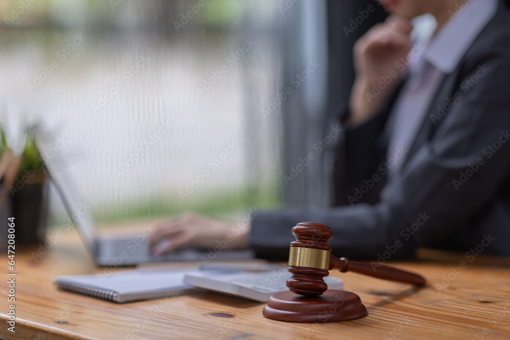 justice and law concept.business asian woman or lawyer or accountant working using a laptop at desk justice and law concept.business asian woman or lawyer or accountant working using a laptop at desk