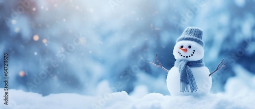 Little snowman in the blurred snow background banner