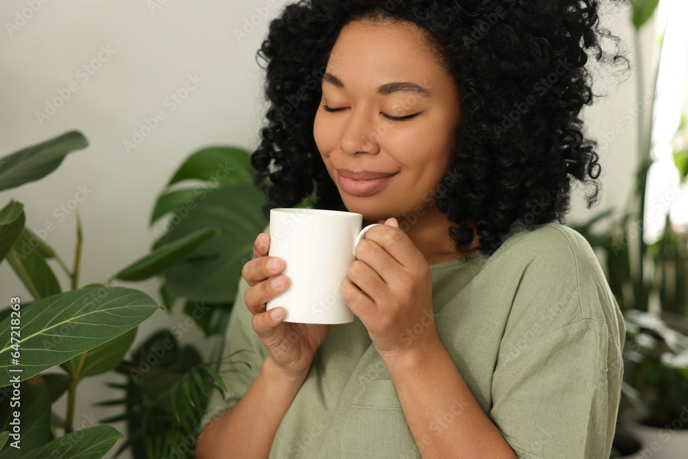 custom made wallpaper toronto digitalRelaxing atmosphere. Happy woman with cup of hot drink near beautiful houseplants