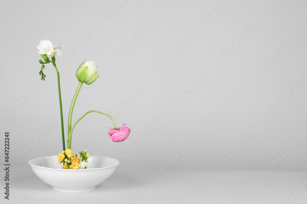 Stylish ikebana as house decor. Beautiful fresh flowers on white background, space for text Stylish ikebana as house decor. Beautiful fresh flowers on white background, space for text