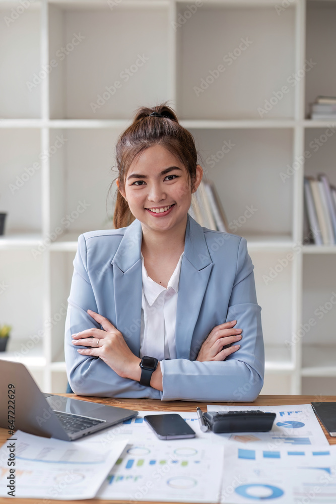 Asian businesswoman use laptop computer in office The Internal Revenue Service audit document balance calculation report is being prepared. Asian businesswoman use laptop computer in office The Internal Revenue Service audit document balance calculation report is being prepared.