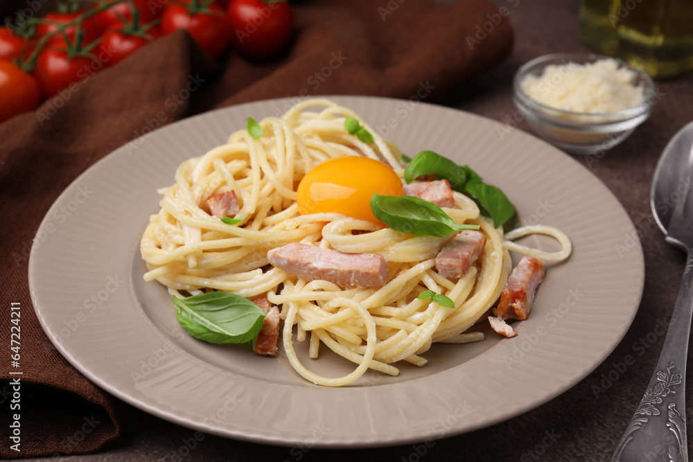 Delicious pasta Carbonara with egg yolk on table, closeup