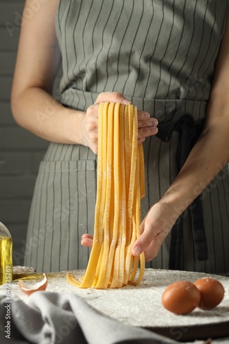 Woman making homemade pasta at table, closeup