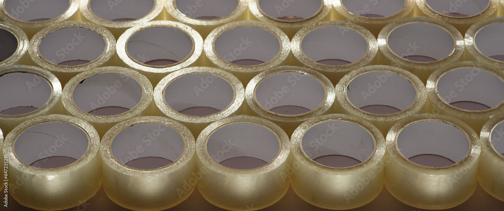 many rolls of transparent tape for packaging goods and mailings in a factory many rolls of transparent tape for packaging goods and mailings in a factory
