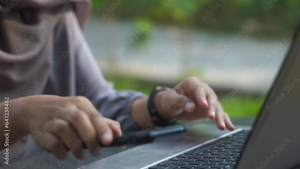 someone is typing on a gray laptop keyboard in the park, someone is having an online meeting with a laptop in a city park someone is typing on a gray laptop keyboard in the park, someone is having an online meeting with a laptop in a city park