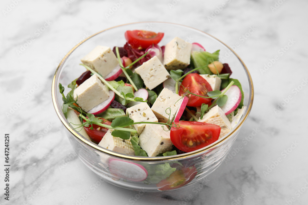 Bowl of tasty salad with tofu and vegetables on white marble table, closeup Bowl of tasty salad with tofu and vegetables on white marble table, closeup