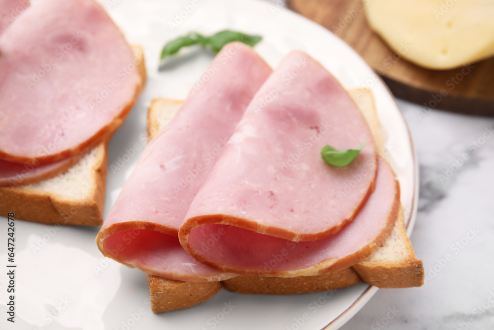 Delicious sandwiches with ham on table, closeup Delicious sandwiches with ham on table, closeup
