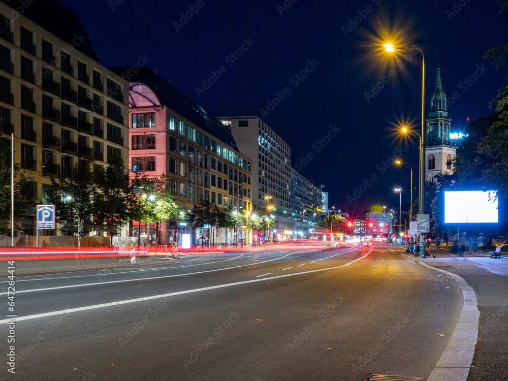 View of the night streets of Berlin and the light trails left by cars. Night European city.