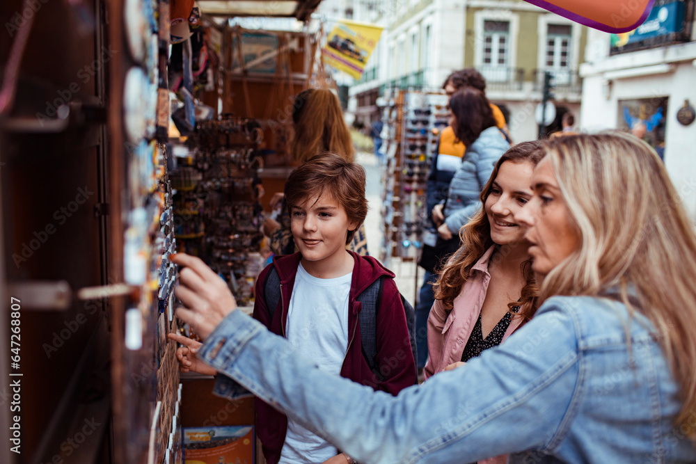 Young Caucasian family traveling and browsing a souvenir shop in the city