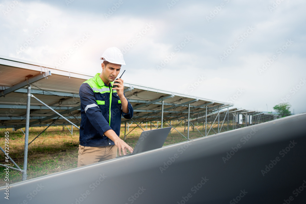 Electrical engineer working with alternative energy solar panels. Male engineer in solar power station.