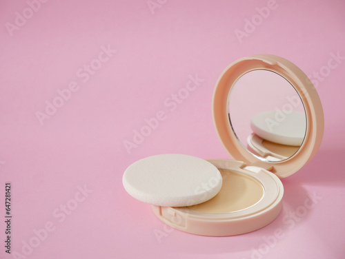 Bilde på lerret Face powder with sponge in beige case on pink background with copy space