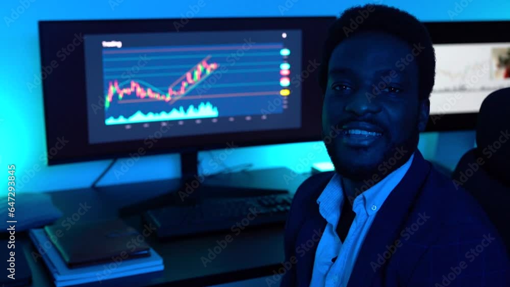 Trader african business man working inside office at night time Trader african business man working inside office at night time