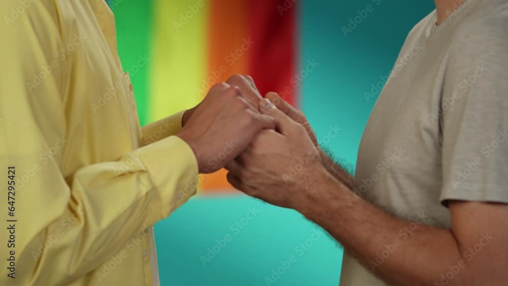 Close up, detail video of a homosexual, pansexual, bisexual male couple standing in front of each other, holding hands and leaning towards each other for a kiss. Close up, detail video of a homosexual, pansexual, bisexual male couple standing in front of each other, holding hands and leaning towards each other for a kiss.