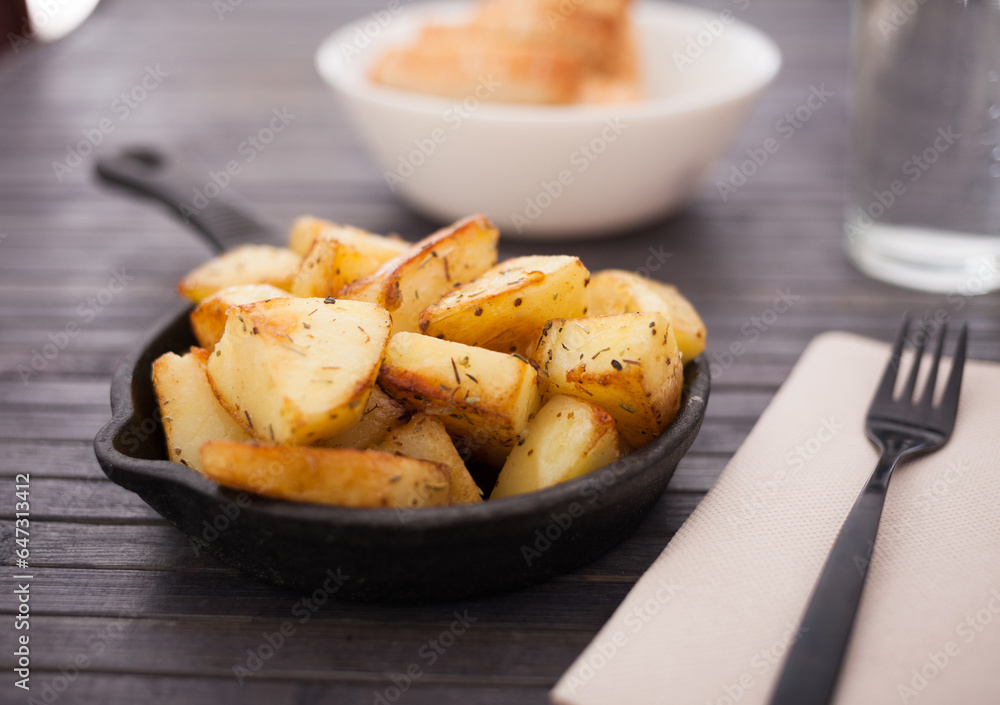 Golden fried potatoes on small cast iron skillet Golden fried potatoes on small cast iron skillet