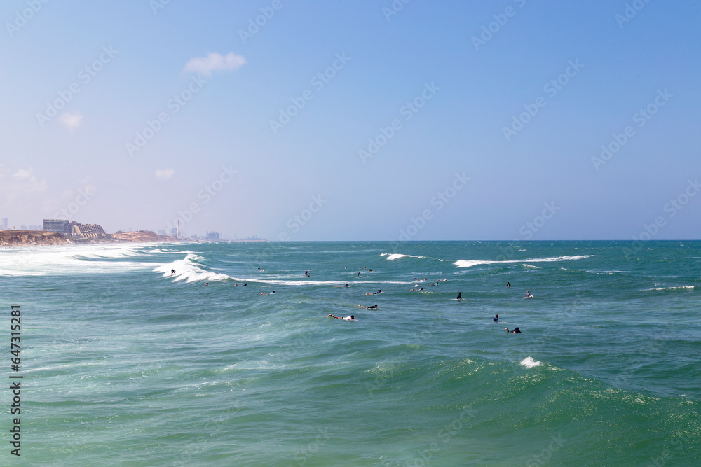 Surfing at the beach of Herzliya in at the coast of Israel