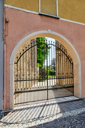 Beautiful ornate wrought iron gate in a backyard in Tuscany  Italy.