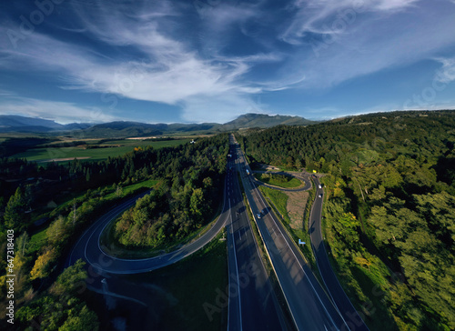 Aerial view of German highway autobahn . Drone shot of highway among forest and green field. Cars fast speed moving on freeway. A7 Kirchheim