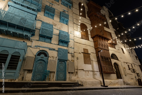 Historical house in the old town of Jeddad with wooden windows and doors at evening lights Saudi Arabia photo