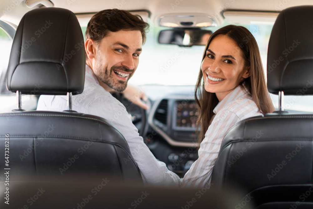 Joyful millennial spouses enjoying travel by car together Joyful millennial spouses enjoying travel by car together