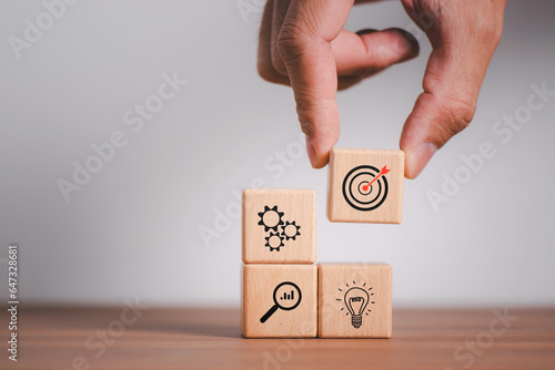 Arrange handmade wooden blocks with business strategies and action plans targeting business ideas. business development concept