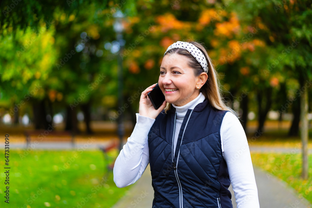 Beautiful woman walking in city park using mobile phone
Beautiful woman walking in city park using mobile phone
