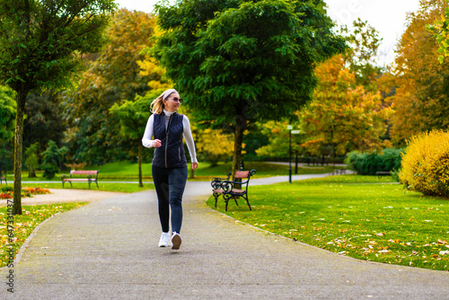 Healthy lifestyle - woman walking in city park
