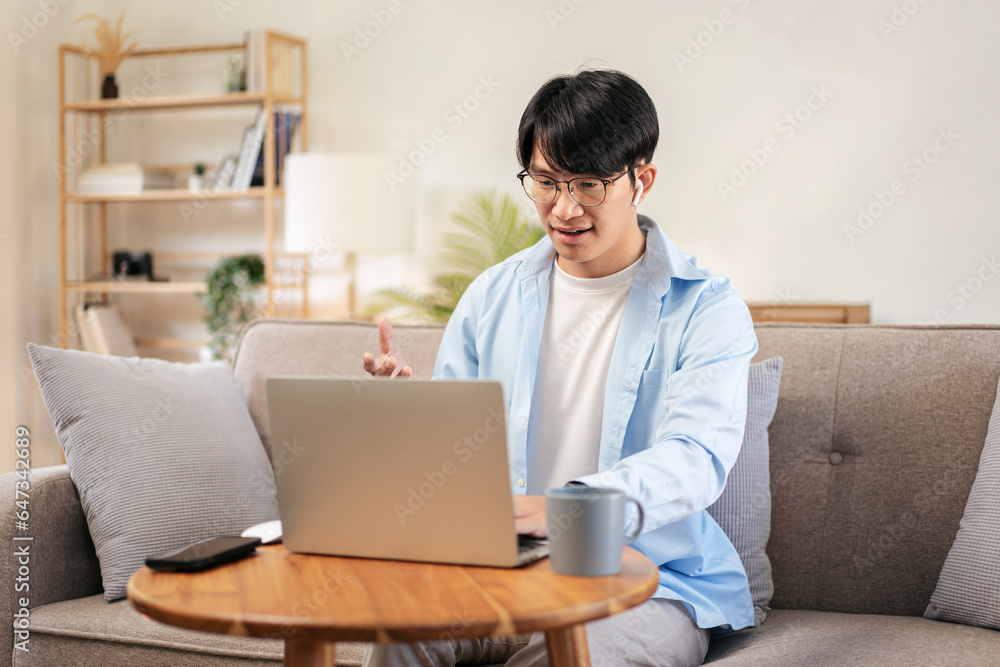 Businessman in casual is sitting comfortable sofa and wearing headphones to explaining business information Businessman in casual is sitting comfortable sofa and wearing headphones to explaining business information