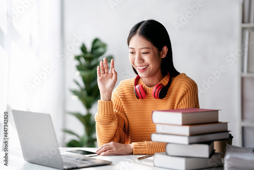 Distance education learning concept, Young woman in sweater studying education lesson online and greeting