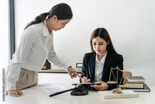 Female lawyer is reading business contract and giving advice about laws and agreements of contract with