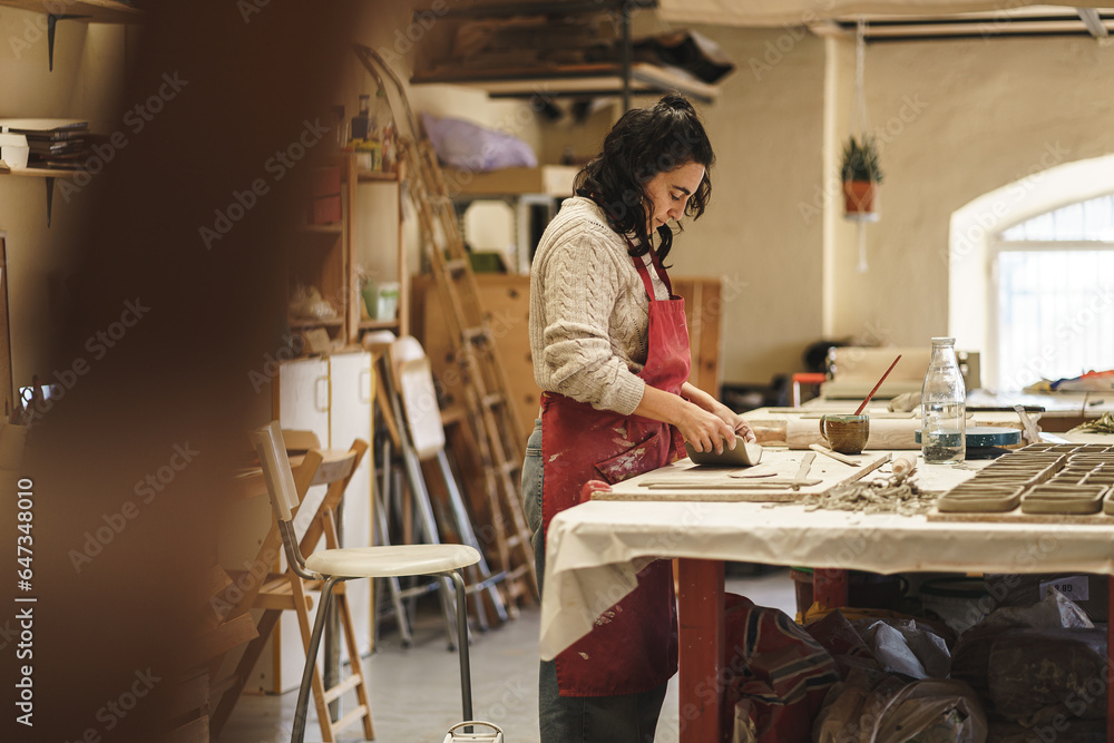 ceramist woman in her workshop working ceramist woman in her workshop working