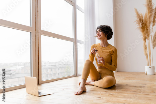 young pretty woman doing yoga at home