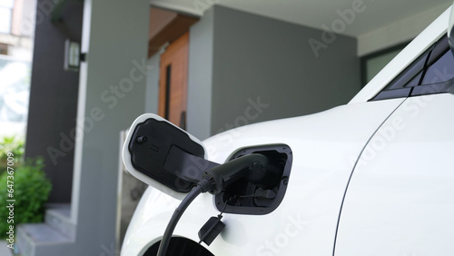 Home charging station providing sustainable, renewable source of power for electronic vehicle, EV cars at home for progressive modern lifestyle. Eco-friendly hybrid electro and petrol vehicle battery.