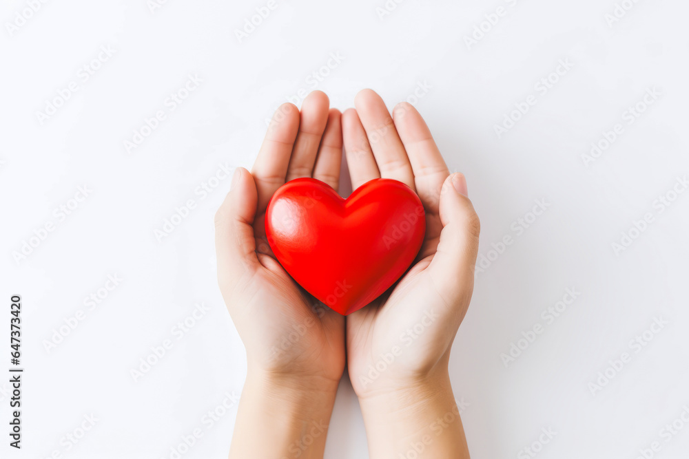 a pair of hands holding a red heart in white background a pair of hands holding a red heart in white background