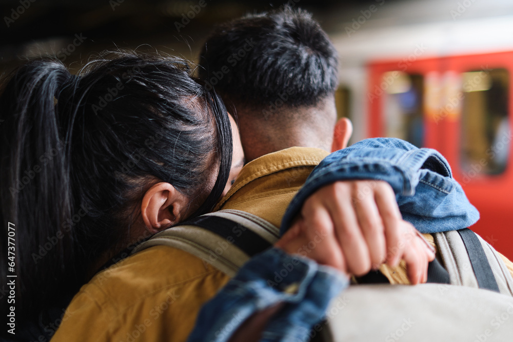 Fototapeta premium Young couple saying goodbye in the subway