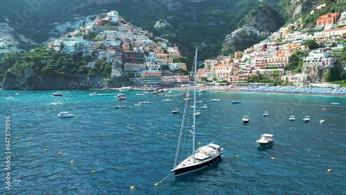 Positano, tourist destination on the Amalfi Coast, Italy. Aerial view of Colorful houses on a Tyrrhenian sea coast seen through green juicy flora in Positano is a village in Naples metropolitan area