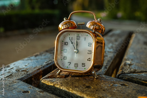 Golden alarm clock on a rus...