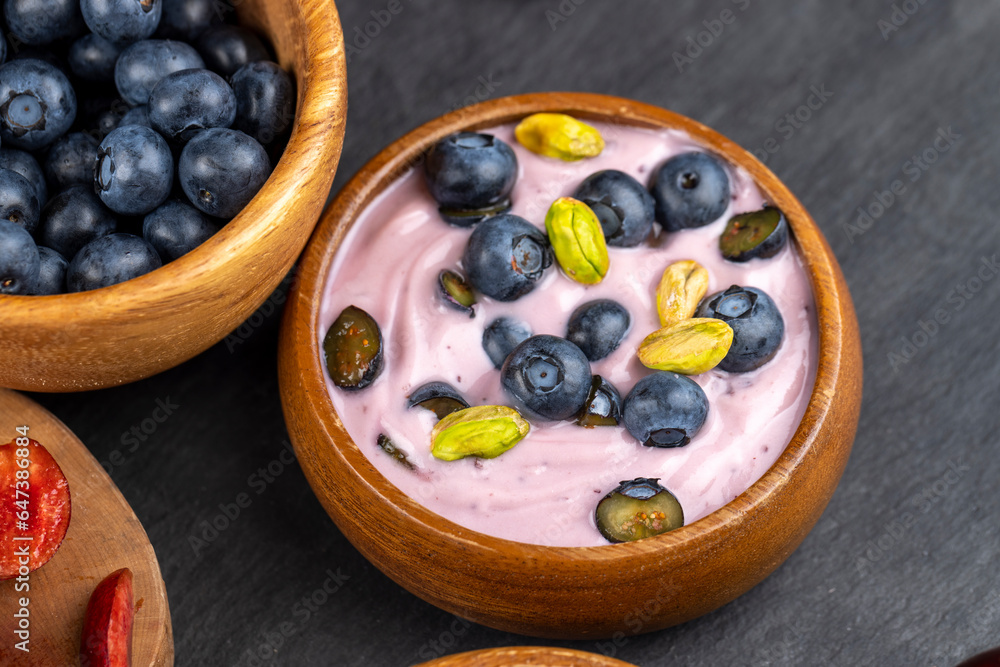 fresh blueberry-flavored yogurt with ripe blueberries and pistachios fresh blueberry-flavored yogurt with ripe blueberries and pistachios