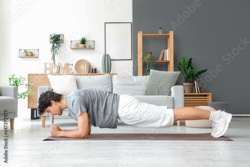 Handsome young man in plank...