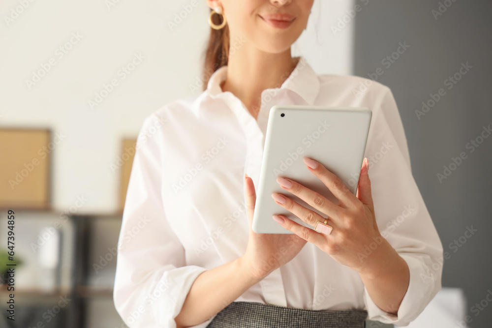 Beautiful businesswoman working with tablet computer in office, closeup Beautiful businesswoman working with tablet computer in office, closeup