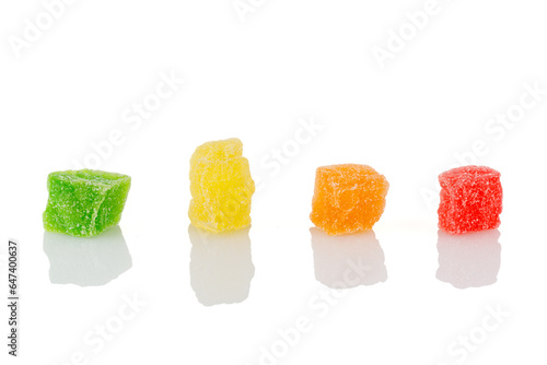 Pieces colored of candied fruits isolated on white. Multicolored dried fruit candies isolated on white background.