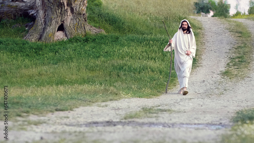Jesus Christ walking on a country road at sunset.