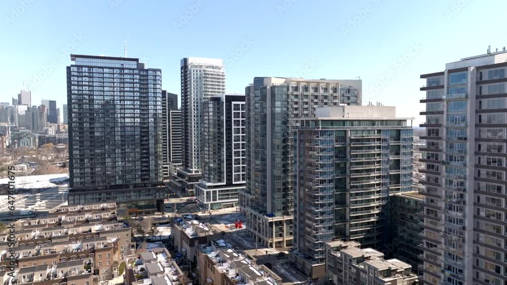Vertical aerial rise over townhomes and highrise condos in Toronto's