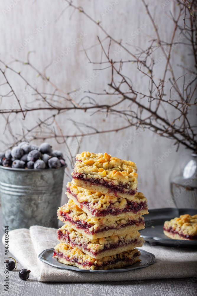 Streusel pie with currant and rose petal filling on a light background.