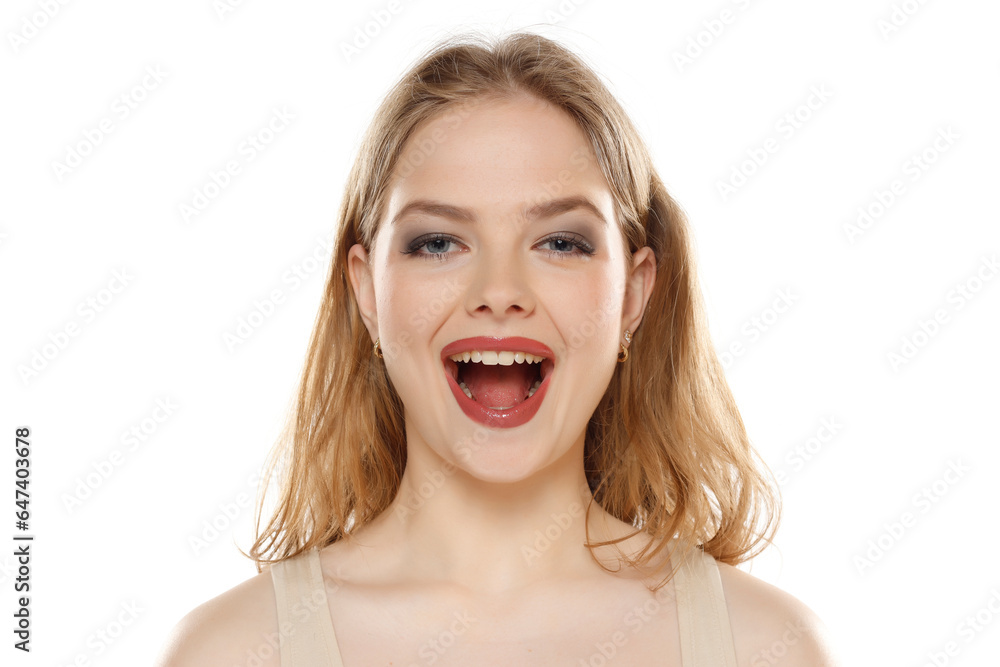 Portrait of young happy blonde woman with open mouth on white background Portrait of young happy blonde woman with open mouth on white background