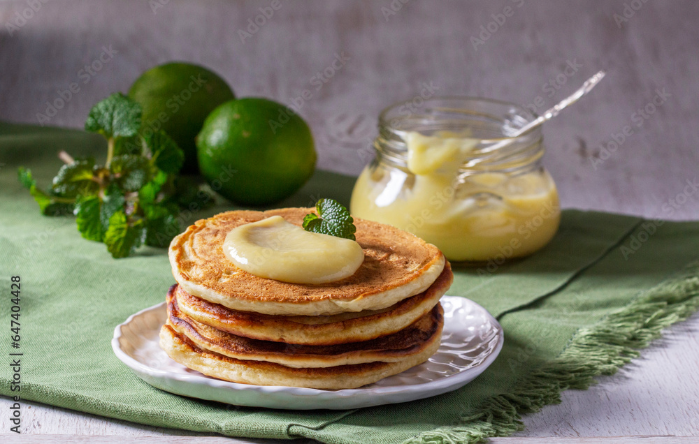 Whole grain flour fritters served with lime curd on a light background. Rustic style.