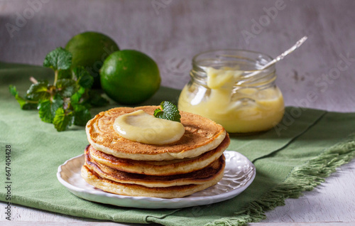 Obraz na płótnie Whole grain flour fritters served with lime curd on a light background. Rustic style. w salonie